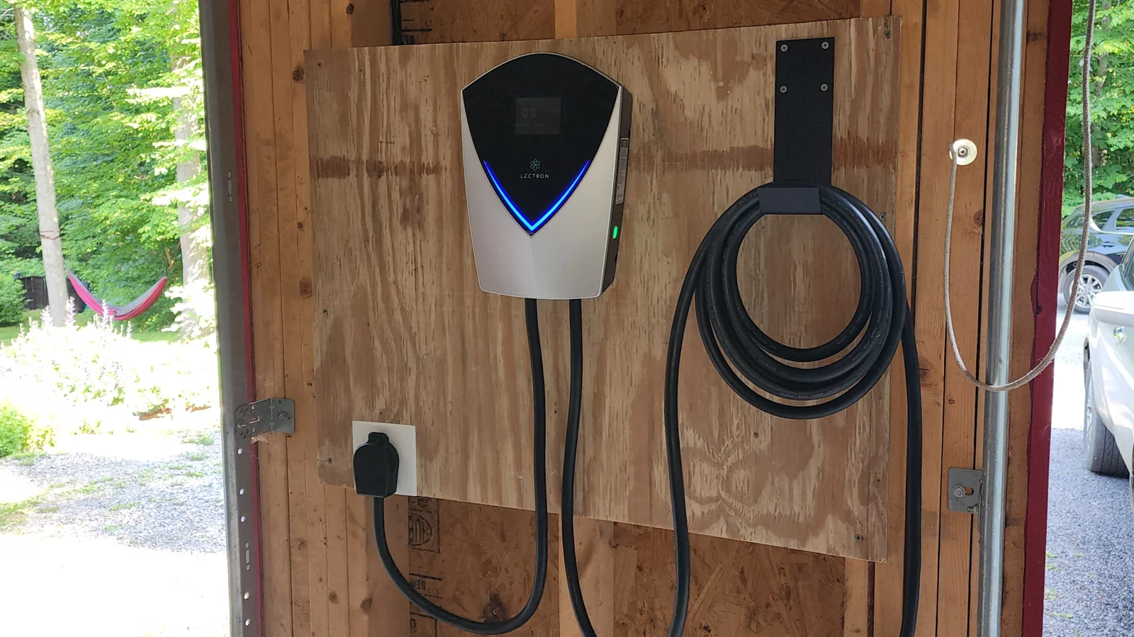 EV charger installed against unfinished garage framing