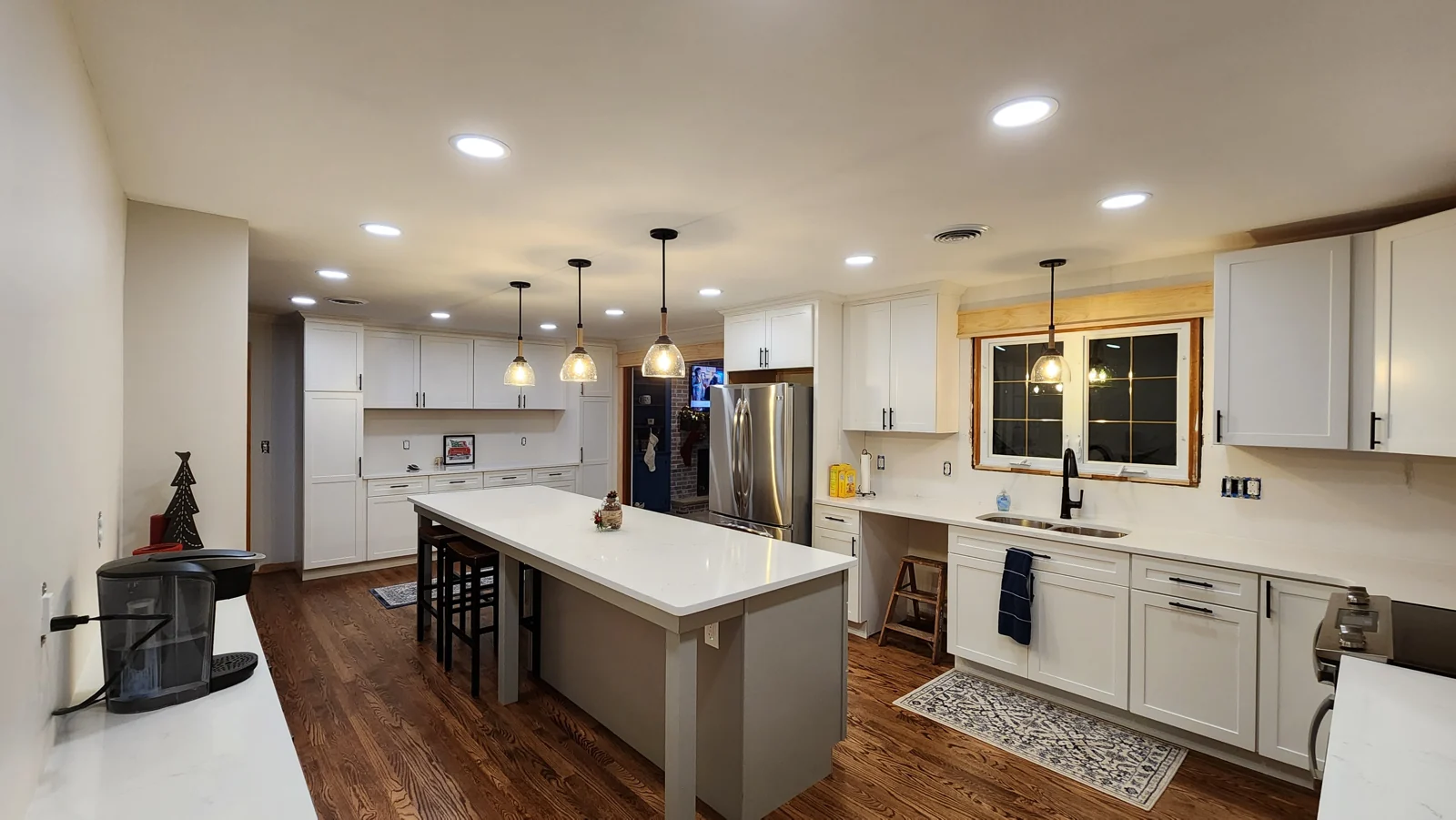 Recessed lighting and pendant fixtures in a completed kitchen