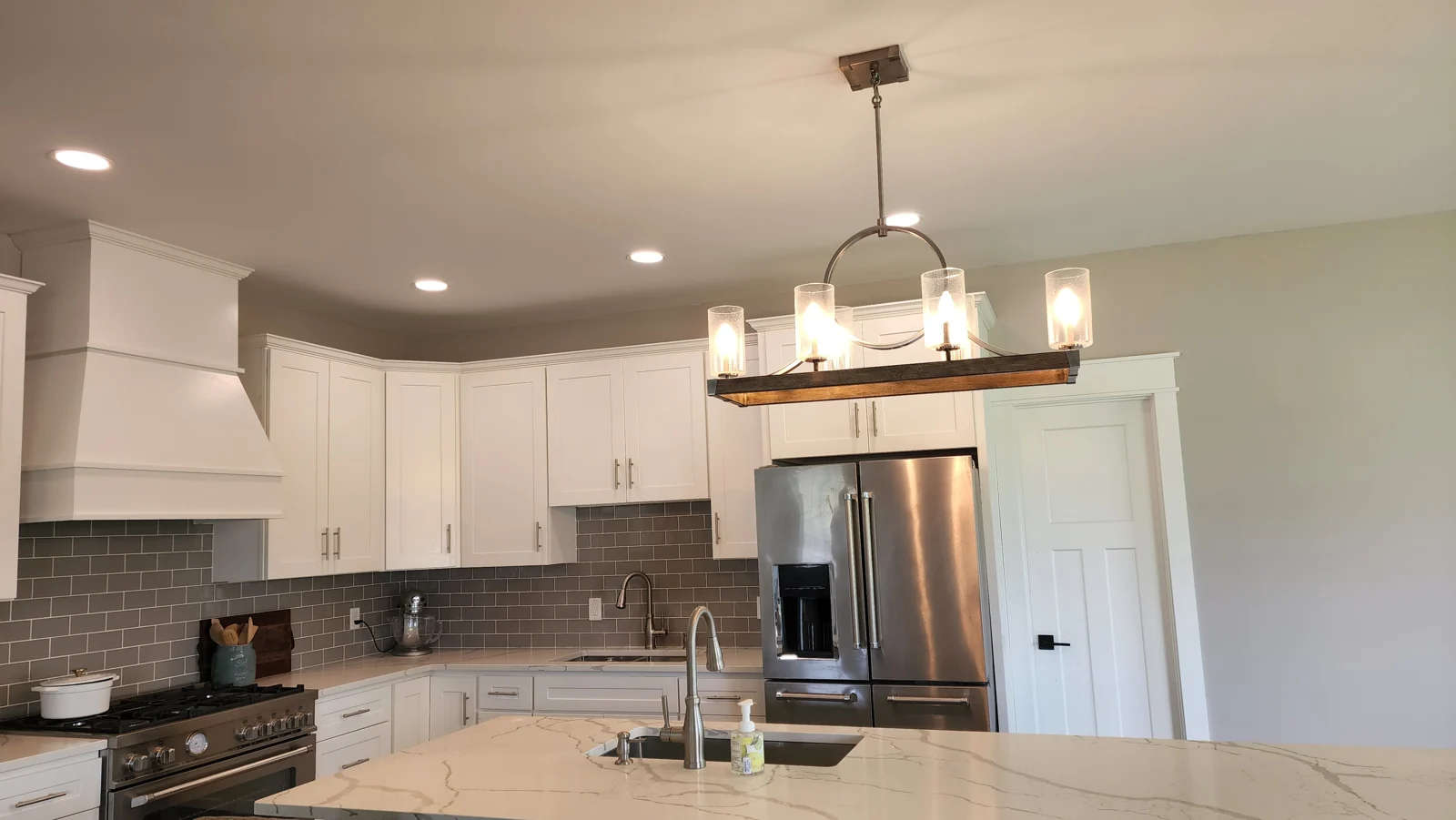 Kitchen with recessed lighting and a decorative hanging fixture